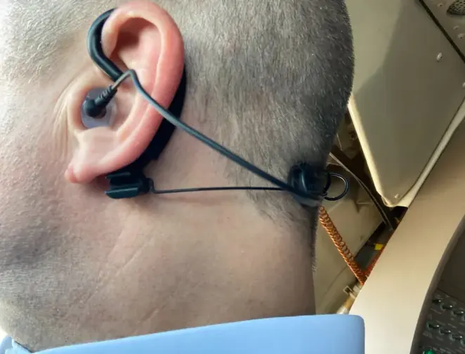 A pilot wearing the custom Clarity Aloft adapter in the cockpit