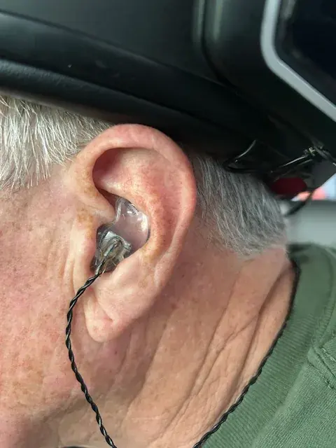 A customer wearing a clear acrylic custom IEM