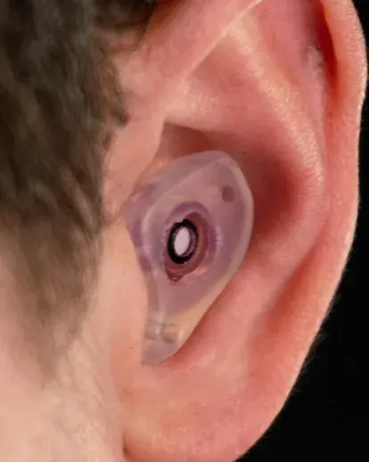 Custom filtered earplug worn and sealed in the ear